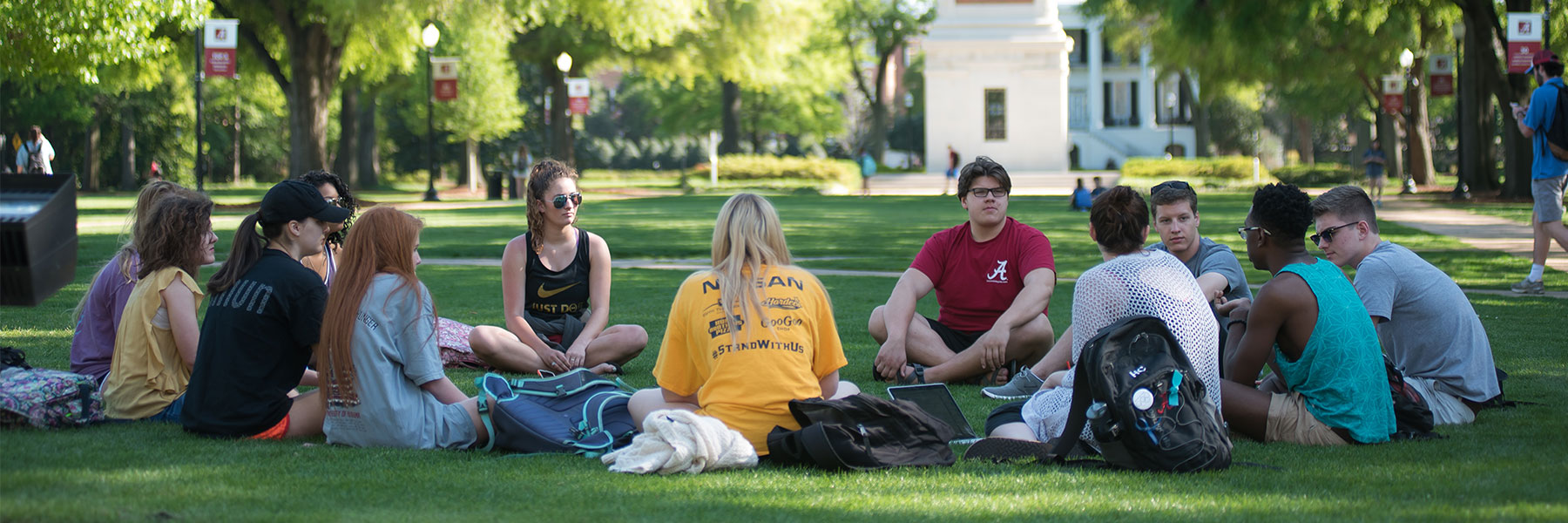 a group of students sitting in a circle on the Quad